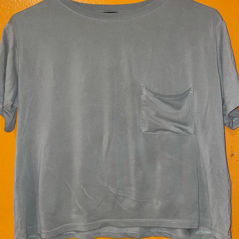 Light green/grey crop top with a pocket